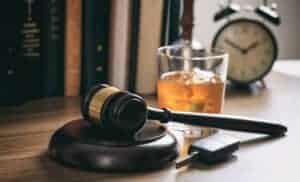 gavel and alcoholic beverage on table