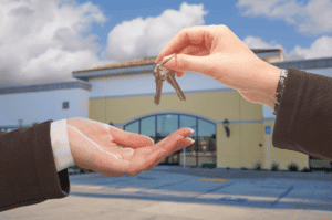 buyer being given keys to purchased commercial property