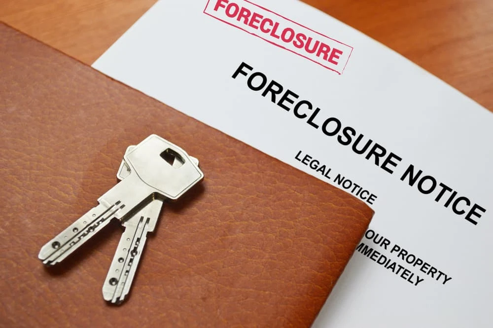 Foreclosure notice with pair of keys on top