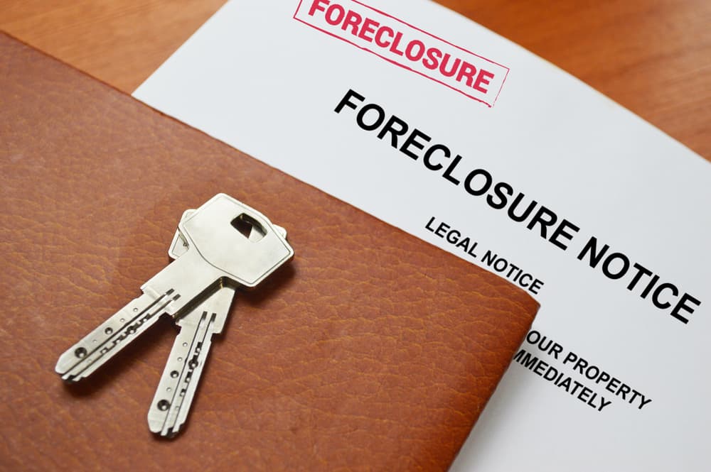Foreclosure notice with pair of keys on top